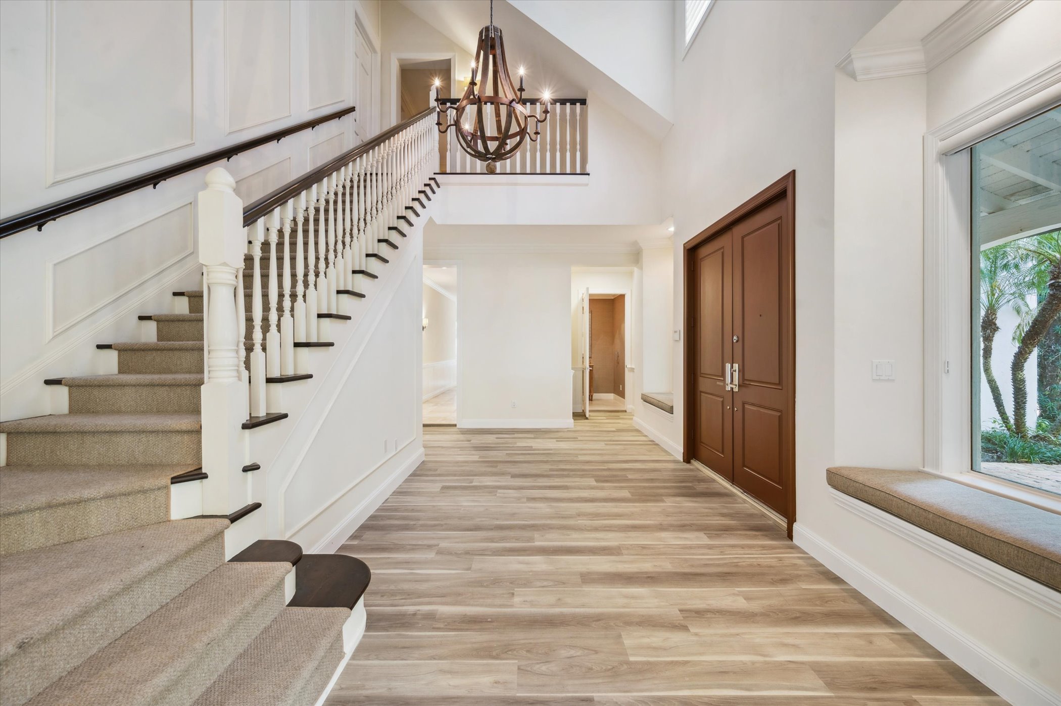 Grand foyer with double-height staircase and chandelier